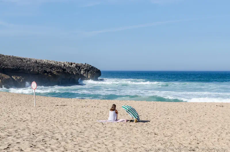 photo: Woman under a parasol on the beach