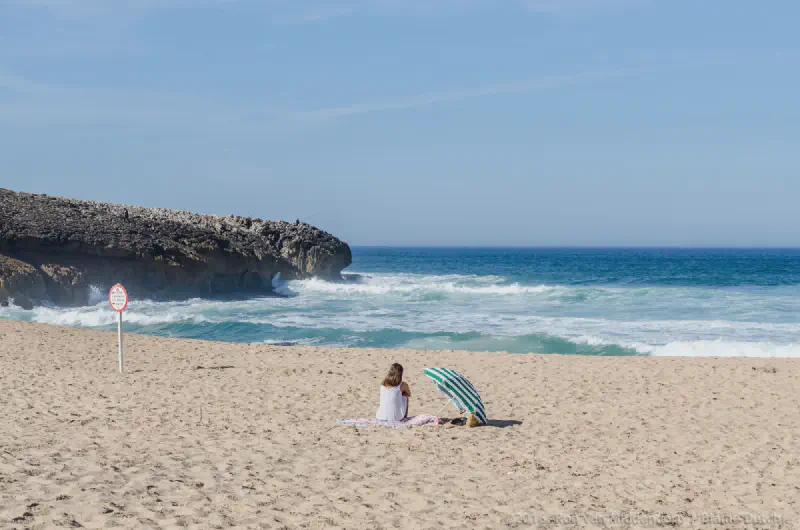 photo: Woman under a parasol on the beach