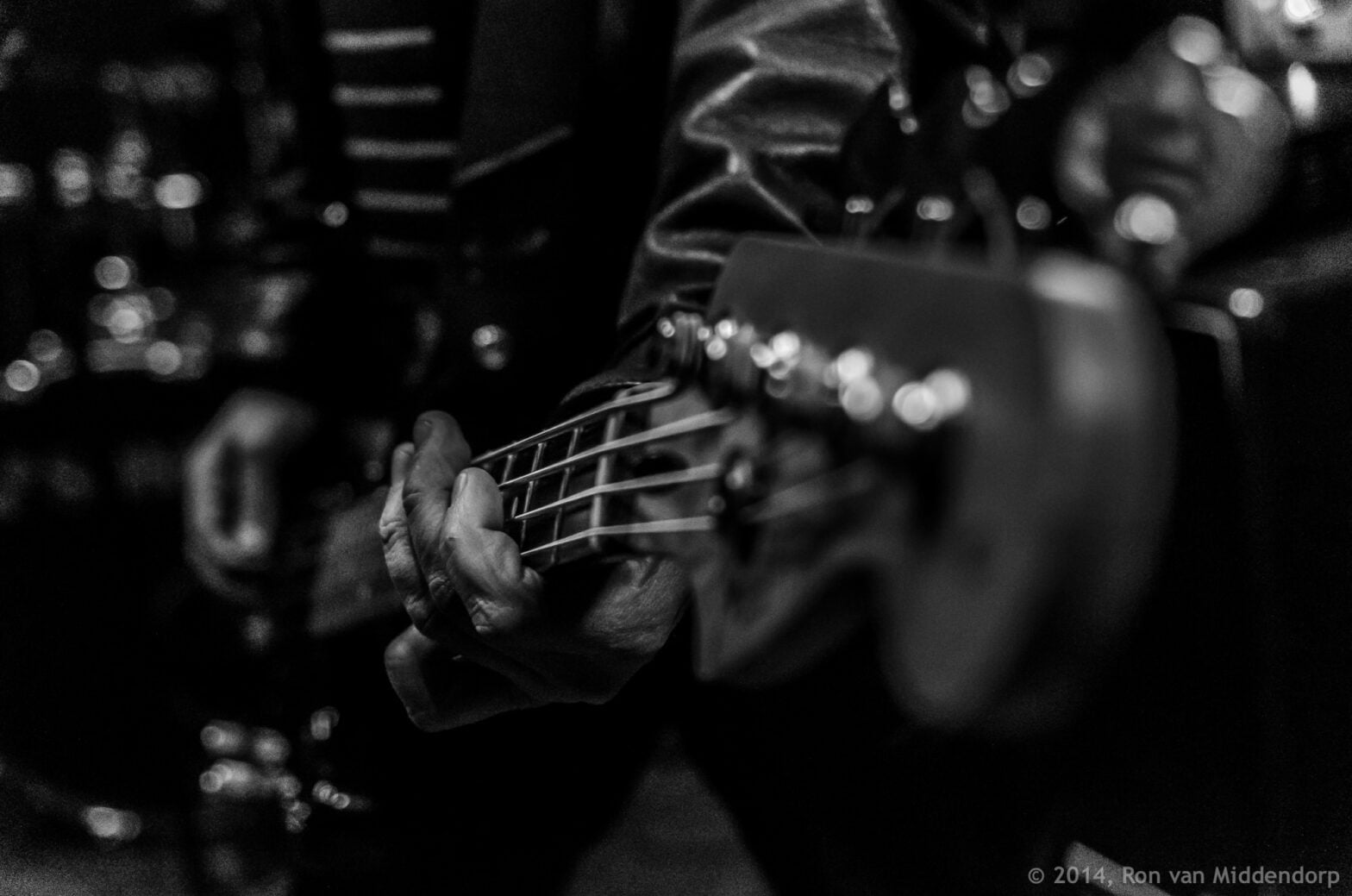 photo: fingers on guitar strings